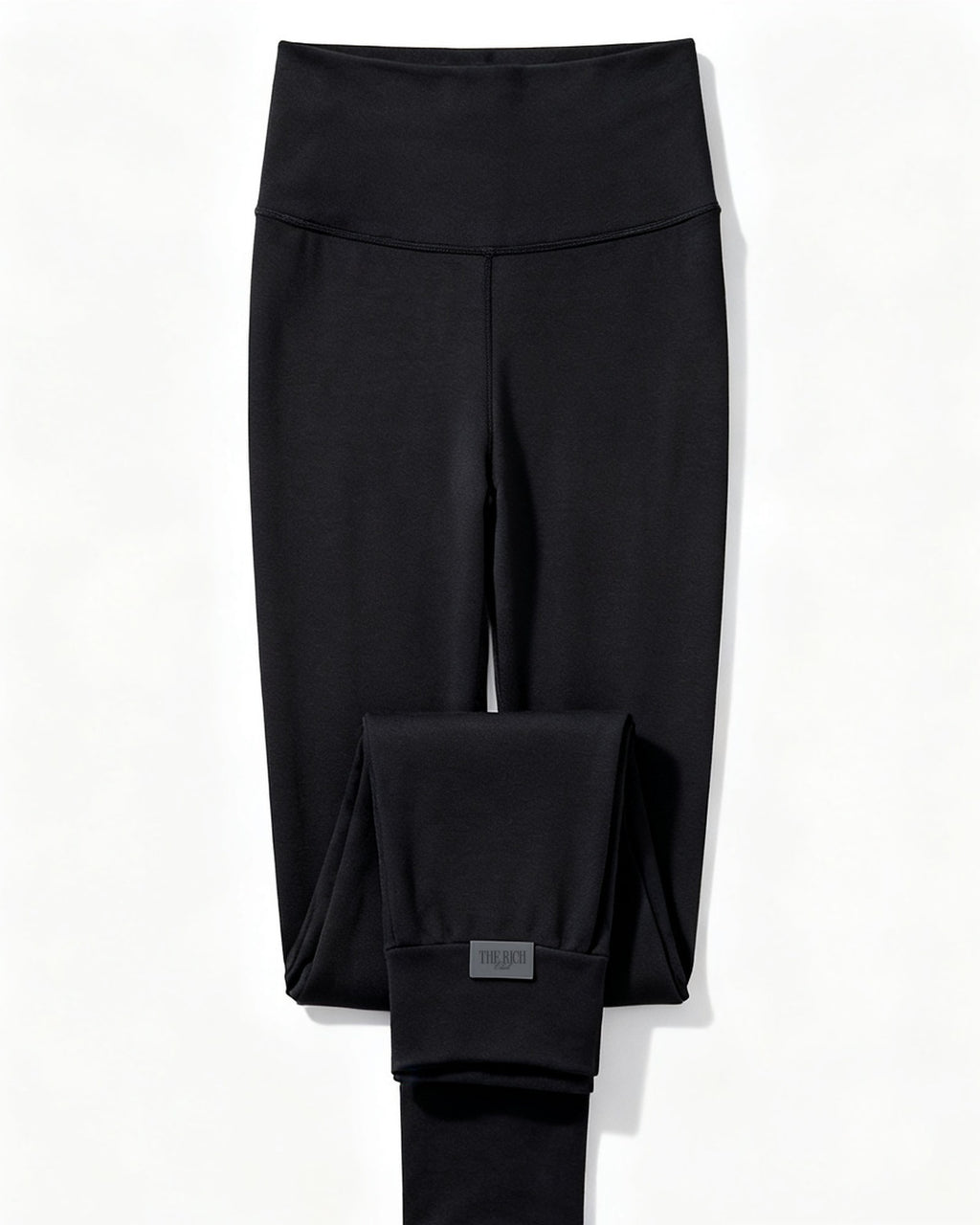 Essential Leggings in Black, flat lay. AI placeholder v2 (pre-production preview, not the final product)