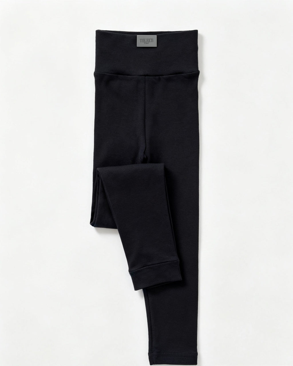 Essential Leggings (Kids) in Black, flat lay. AI placeholder v2 (pre-production preview, not the final product)