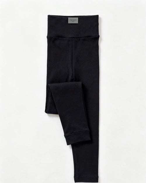 Essential Leggings (Kids) in Black, flat lay. AI placeholder v2 (pre-production preview, not the final product)