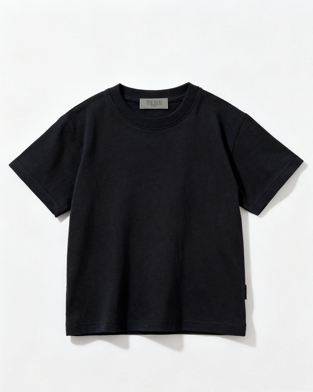 Heavyweight Tee (Kids) in Black, flat lay. AI placeholder v2 (pre-production preview, not the final product)